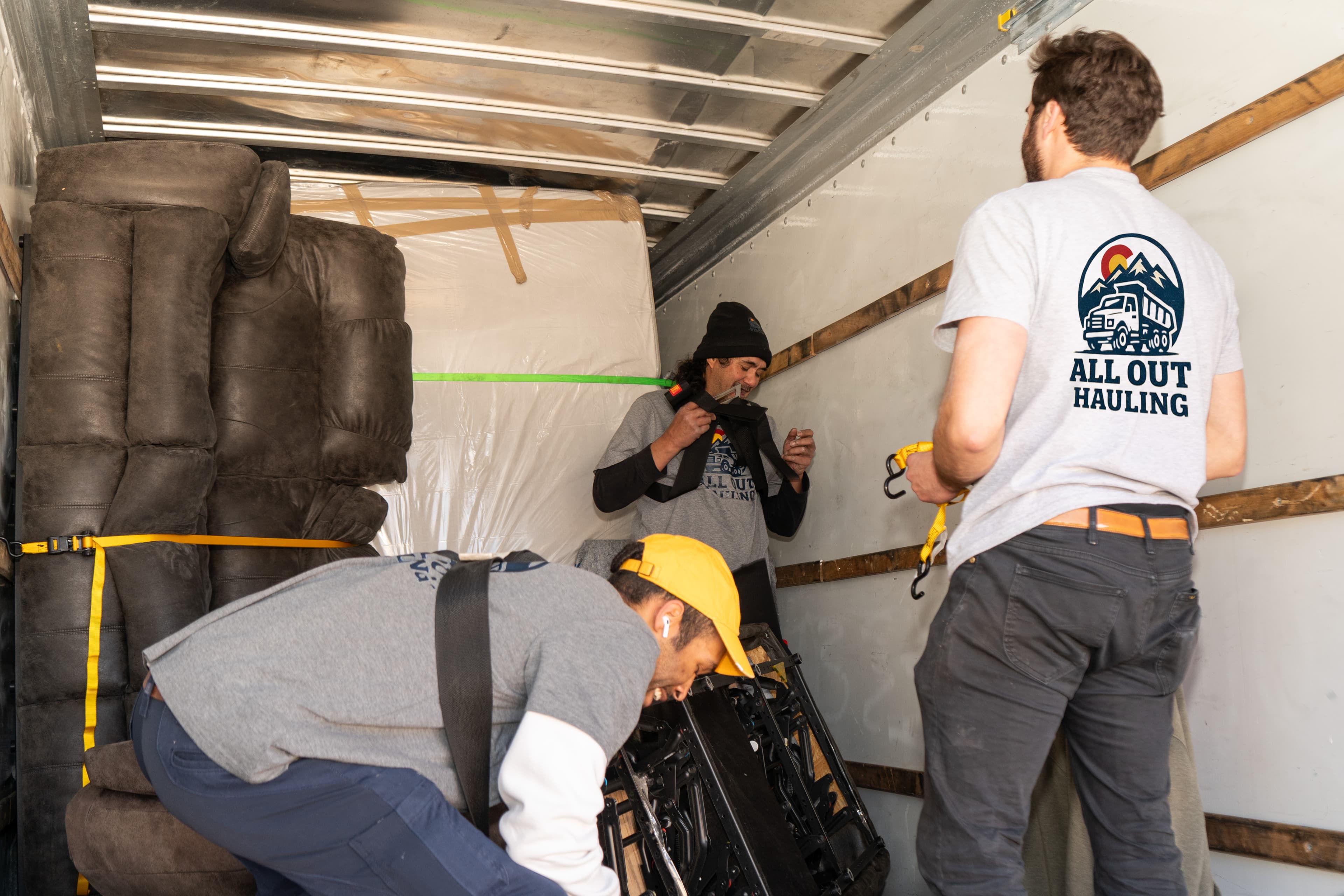 All Out Hauling crew working inside a moving truck